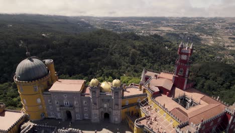 Pull-out-reveal-shot-of-colorful-facade-romanticist-castle,-national-palace-of-Pena-in-Sintra-Portugal