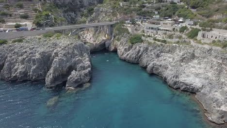 Aerial-flyback-ascending-from-Ponte-Ciolo-or-Ciolo-bridge-in-Puglia,-Italy