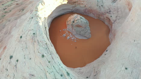 Drone-Aerial-View-of-Cosmic-Ashtray,-Unique-Rock-Formation-With-Sand-in-Utah-USA