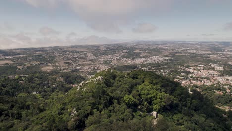 Dolly-in-shot-capturing-the-vast-expanse-of-Sintra-mountaintop-landscape-with-Castelo-dos-Mouros