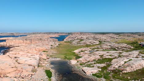 Beautiful-Smooth-Granite-Shoreline-Of-Bohuslan-Under-Clear-Blue-Sky-In-Gotaland,-Sweden