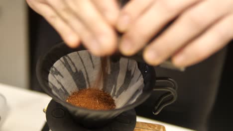 Fresh-roasted-coffee-pouring-in-a-filter-over-glass-jar