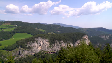 Panoramic-Aerial-view-of-rocky-cliffs-in-incredible-green-European-mountain-landscape