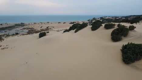 Dune-di-Piscinas,-a-big-massive-sand-desert-dune-by-the-seaside-with-a-sandy-ocean-sea-beach-on-the-island-Sardinia,-Italy