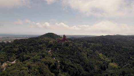 One-of-the-seven-wonders,-the-famous-colorful-Pena-palace-in-Sintra-Portugal,-aerial-dolly-in-shot