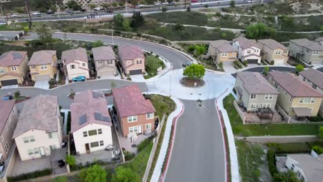 Aerial:-white-vehicle-driving-through-Los-Angeles-neighborhood-suburb