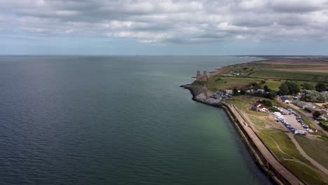 A-4K-high-drone-shot-showing-the-coast-line-Reculver-in-Kent-featuring-the-historic-Reculver-Towers