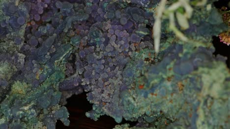 Unique-green-purple-and-orange-geode-rock-formation-crystal-close-up-with-macro-light-bizarre-alien-like-and-other-worldly