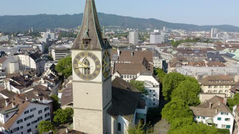 Amazing-Aerial-View-of-Church-of-Saint-Peter-in-Downtown-Zurich,-Switzerland---Pullback-Reveal