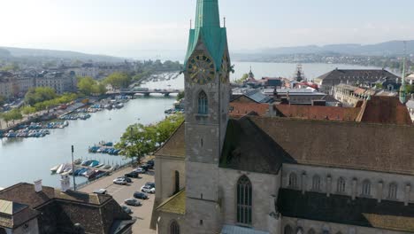 Aerial-Establishing-Shot-of-Fraumünster-Church-with-Limmat-River-and-Lake-Zurich-in-Background