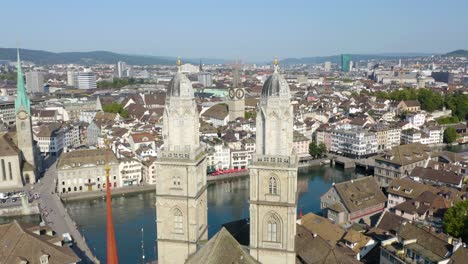 Beautiful-Close-Up-Aerial-View-of-Grossmünster,-Church-of-St-Peter-in-Zurich,-Switzerland