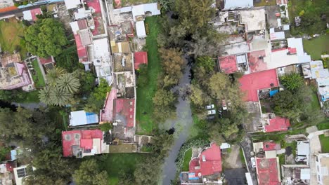 Slowly-jib-upabove-houses-and-canal-in-Xochimilco