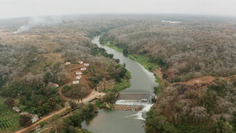 Traveling-up-over-a-river,-dam-on-a-river-in-Angola,-Africa-1