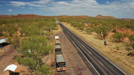 Trucks-Park-By-The-National-Road-Of-Northern-Territory-With-Traffic-On-Sunny-Day,-Outback-Australia