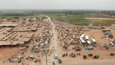 traveling-front-over-the-informal-market,-Caxito-in-Angola,-Africa