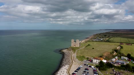 A-very-wide-high-altitude-drone-shot-of-Reculver-Towers-with-the-sea-and-the-sky-in-the-background