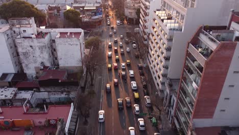 Aerial-forward-over-busy-street-of-Buenos-Aires-at-sunset,-Argentine