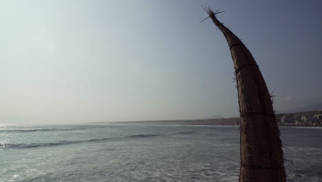 A-Traditional-Caballito-de-totora-Boat-Standing-Along-the-Beach-in-Huanchaco,-Trujillo,-La-Libertad,-Peru