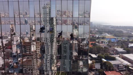 AERIAL---Window-washers,-high-rise-building,-Buenos-Aires,-Argentina,-circle-pan
