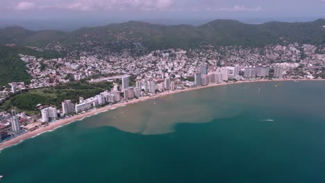 Aerial-dolly-out-above-tranquil-Mexico-city-seaside-coast-at-day,-wide-angle