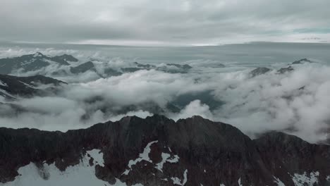 Timelapse-with-a-drone-of-a-mountain-landscape-with-fast-moving-clouds-in-the-Alps
