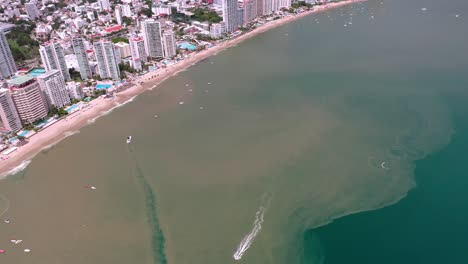 Aerial-drone-shot-of-Mexico-City-next-to-beautiful-ocean-seaside-coast