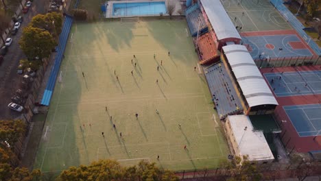 AERIAL---People-playing-football-in-Buenos-Aires,-Argentina,-forward-tilt-down