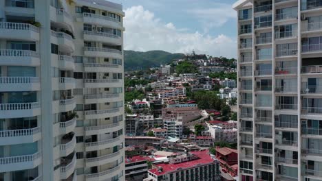 Aerial-drone-pedestal-shot-of-Acapulco-city-Mexico-at-day,-wide-angle
