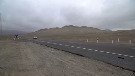 An-approaching-vehicle-on-a-rural-highway-in-Gramita,-Casma,-Ancash,-Peru,-South-America