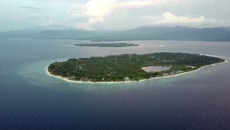Aerial-footage-of-a-little-island-isolated-in-the-middle-of-the-ocean,-tropical-paradise