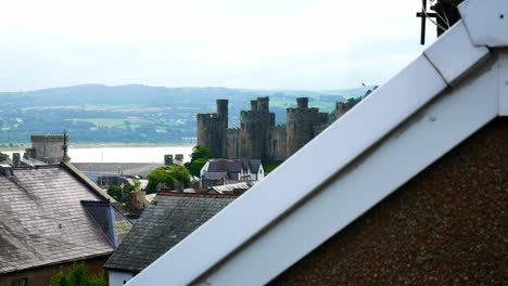 Residential-house-rooftop-apex-inside-Conwy-castle-harbour-above-townscape-dolly-left
