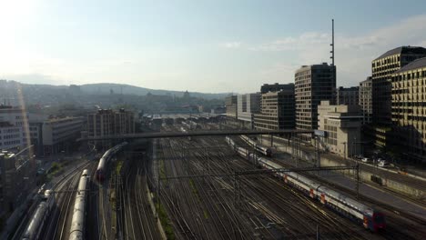Aerial-Establishing-Shot-of-Trains-Arriving-at-Central-Rail-Station-in-European-City