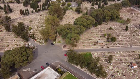 Aerial-flyover-parking-area-of-La-Chacarita-Cemetery-in-Buenos-Aires-during-daytime