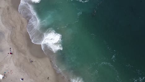 Top-down-shot-of-green-and-white-waves-on-Laguna-beach