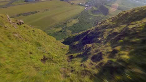 FPV-drone-proximity-flying-down-hill-in-Vik,-Iceland