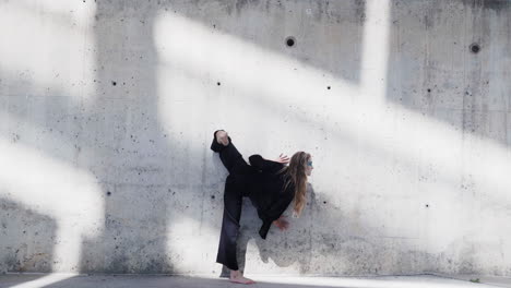 Shadow-ballet-dance-form-practice-at-a-grungy-wall