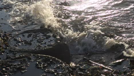 close-up-slow-motion-ocean-waves-crashing-against-the-beach-barrier