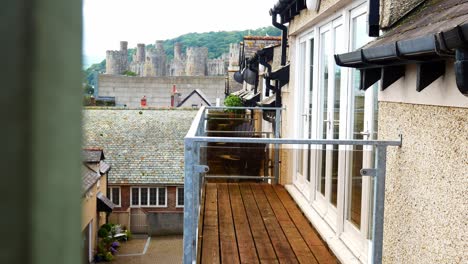 Luxury-Conwy-glass-balcony-apartment-balcony-property-with-castle-waterfront-views-above-rooftops-dolly-right