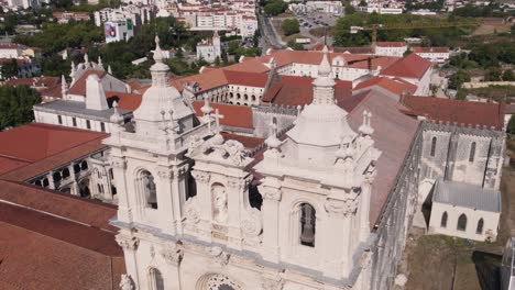 Aerial-panning-shot-capturing-the-details-facade-of-Monastery-of-Alcobaça,-Portugal