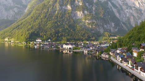 Incredible-Aerial-View-of-Small-Village-Tucked-Between-Mountains-and-a-Lake