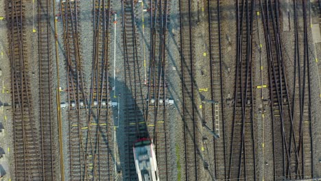 Top-Down-Aerial-View-of-Train-on-One-of-Many-Tracks-in-Central-Station