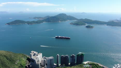 Mega-Container-Ship-leaving-Hong-Kong-bay,-Aerial-view