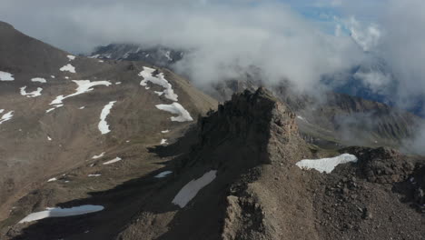 Aerial-of-rocky-mountain-wall-on-summit