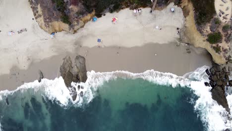 Calm-Tidal-Waves-Washing-On-Beach-Shore,-Top-Down-Aerial-Flying-Towards-Land