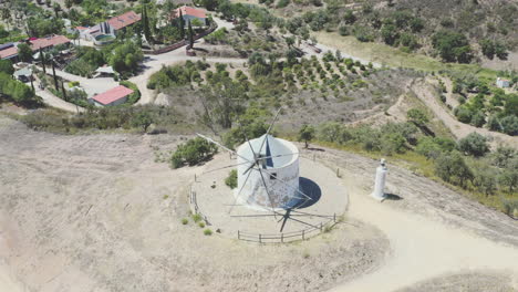 Drone-flight-over-an-old-traditional-Portuguese-windmill-on-a-mountain,-round-tour