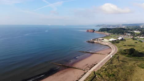 Aerial-Looking-Out-To-Calm-English-Channel-Waters-From-Dawlish-Warren-Beach