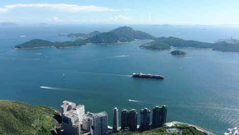Mega-Container-Ship-leaving-Hong-Kong-bay,-Aerial-view