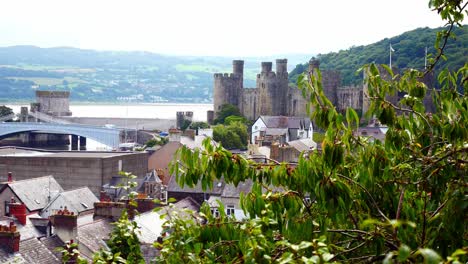 High-angle-view-of-river-Conwy-castle-and-river-bridge-over-Victorian-house-rooftop-chimneys