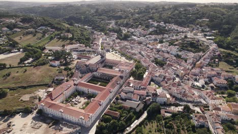 Drone-hovering-toward-historical-site,-Alcobaca-monastery-complex,-birds-eye-view