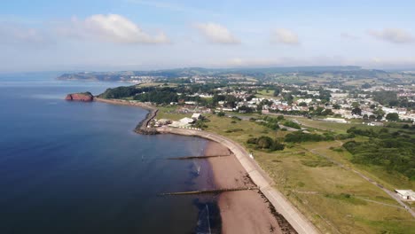 Aerial-Along-Dawlish-Warren-Beach-With-Town-In-Distance